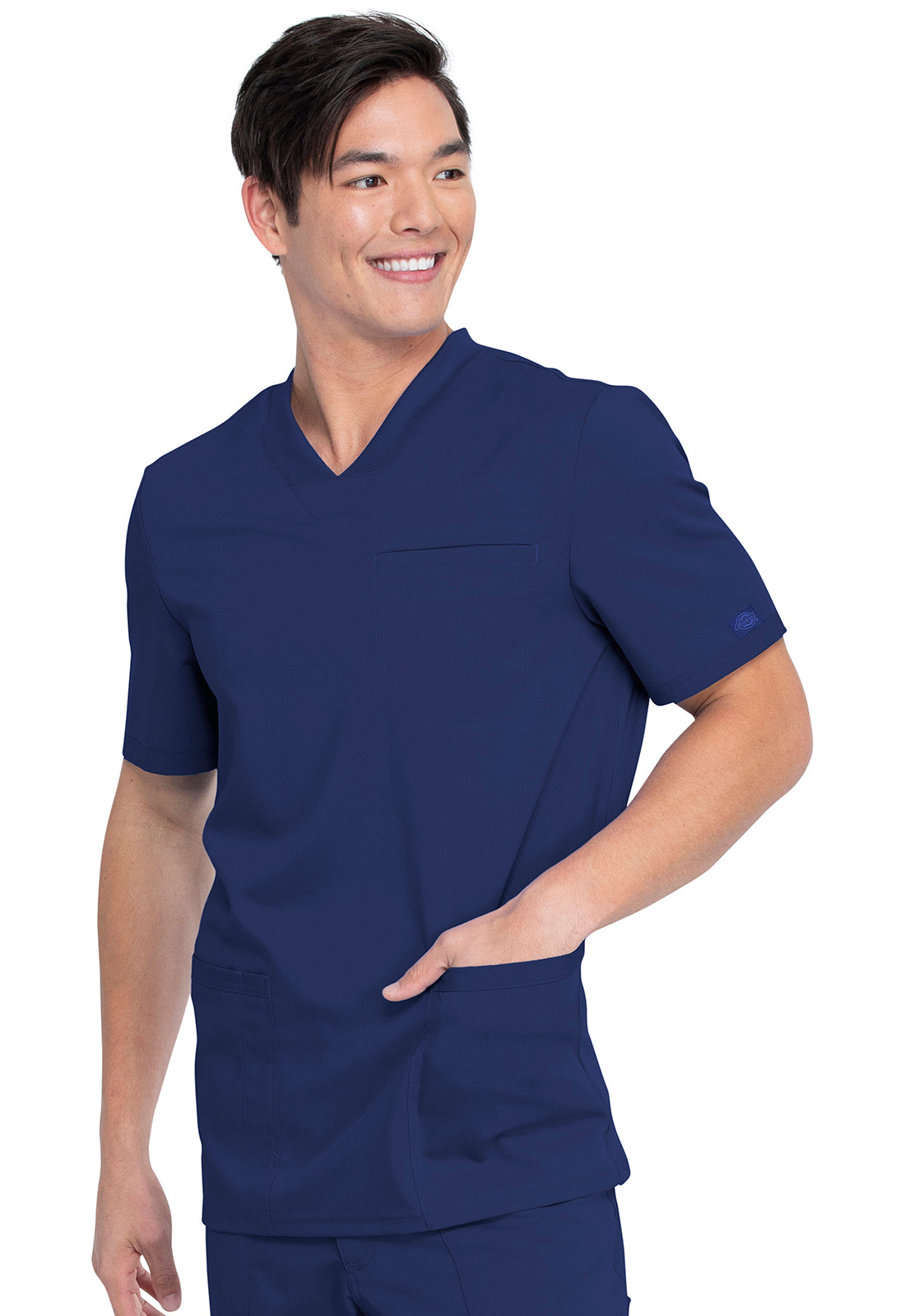 Tunique médicale Balance by Dickies avec poches plaquées portée par une personne souriante